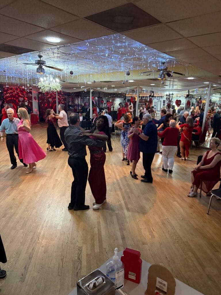 Happy couple dancing Swing at social dance event in Sarasota The Ballroom of Sarasota