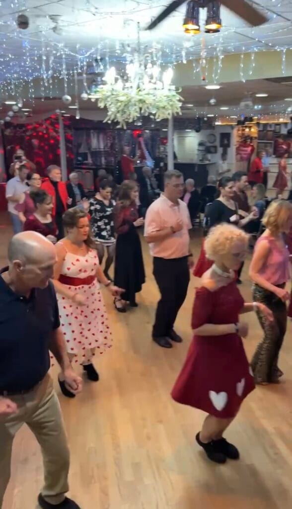 Group of people dancing in a mixer format at Valentine’s Day party Sarasota no partner needed